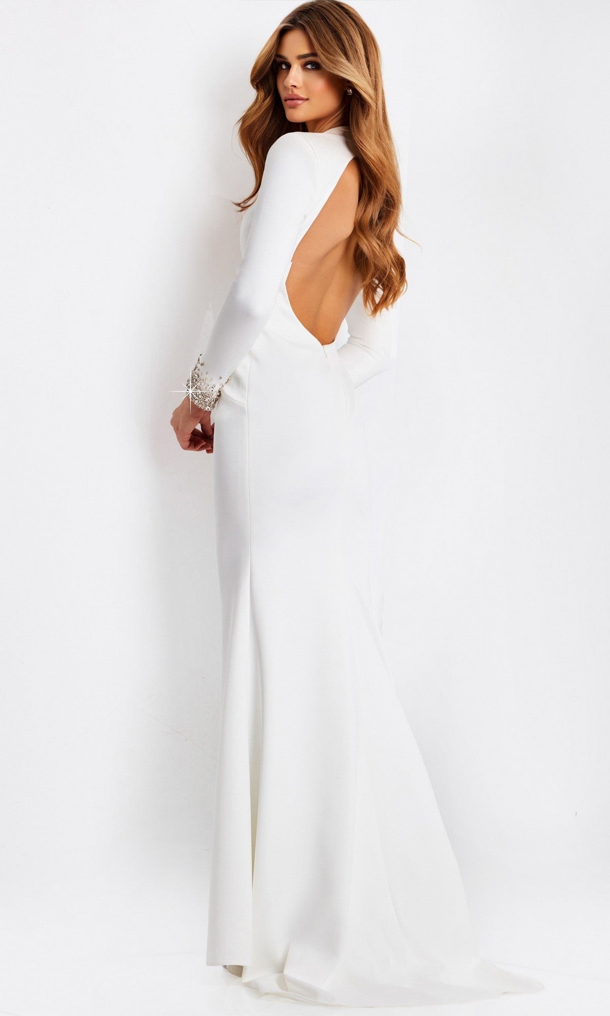 A woman stands against a plain white background, looking over her shoulder in the fitted sheath Long Prom Dress: Jovani 49126 with long sleeves and an open back.